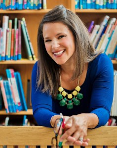 Photo of Maria Dismondy with shelves of books in the background